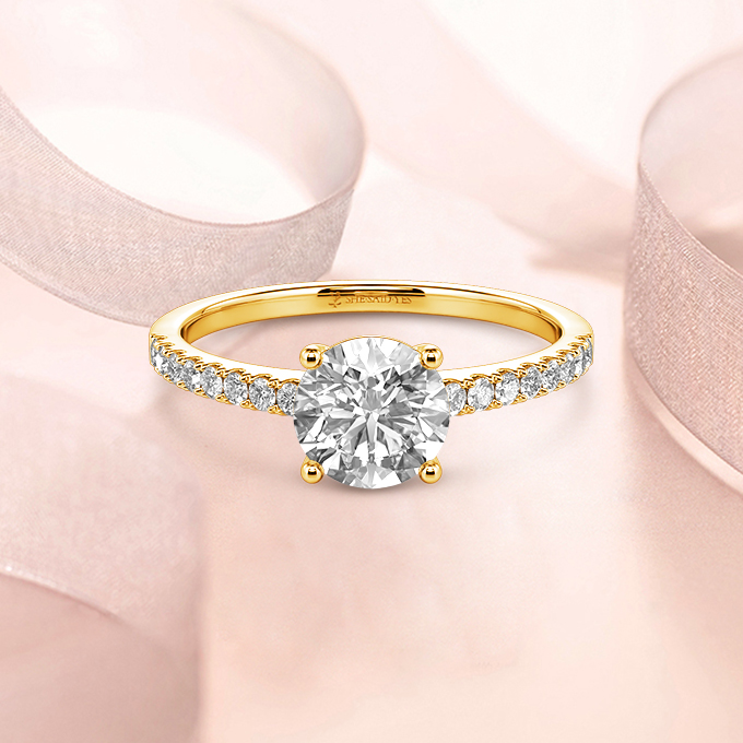 round-cut side-stone engagement ring