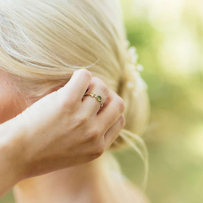 a bride with peridot engagement ring