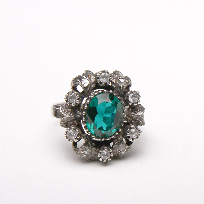 vintage halo ring with an emerald center stone
