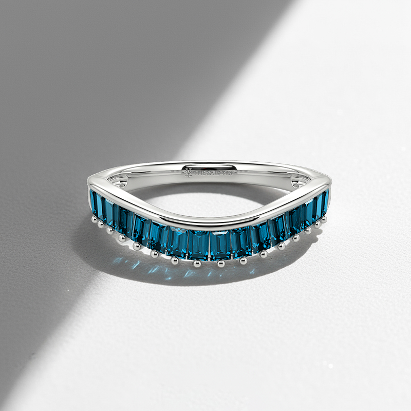white gold wedding band with swiss blue gemstones