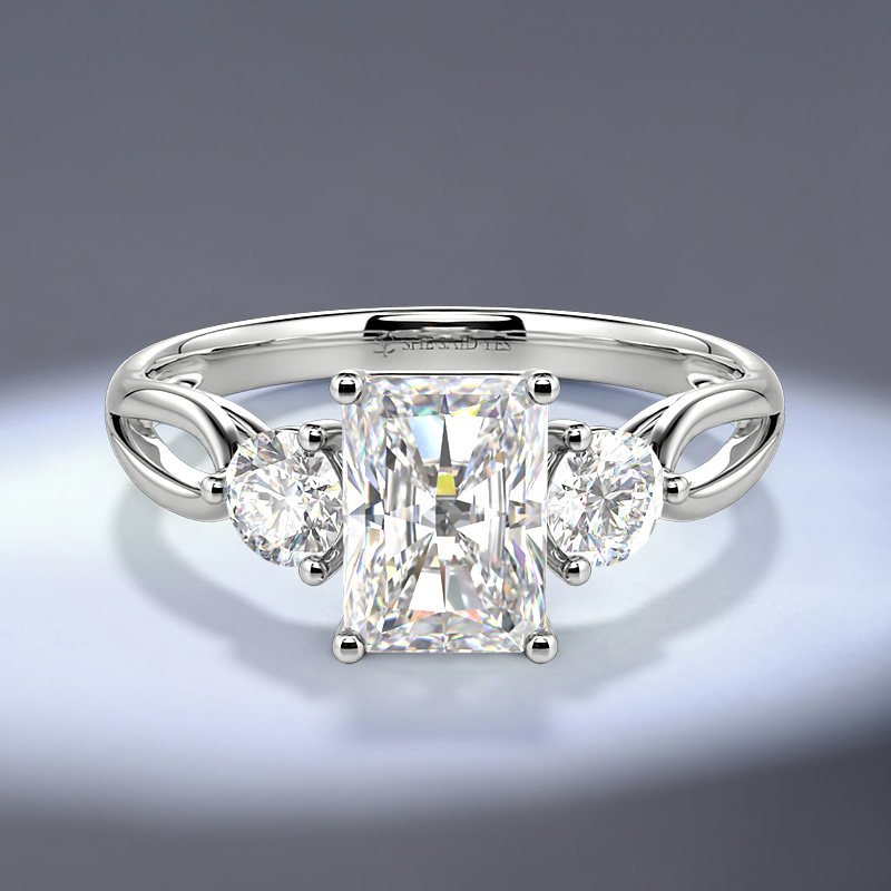radiant-cut three-stone engagement ring with round side stones