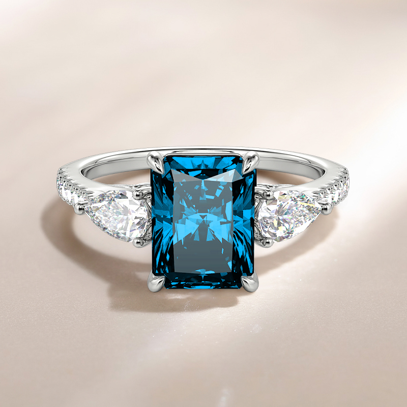 engagement ring with Swiss blue center stone