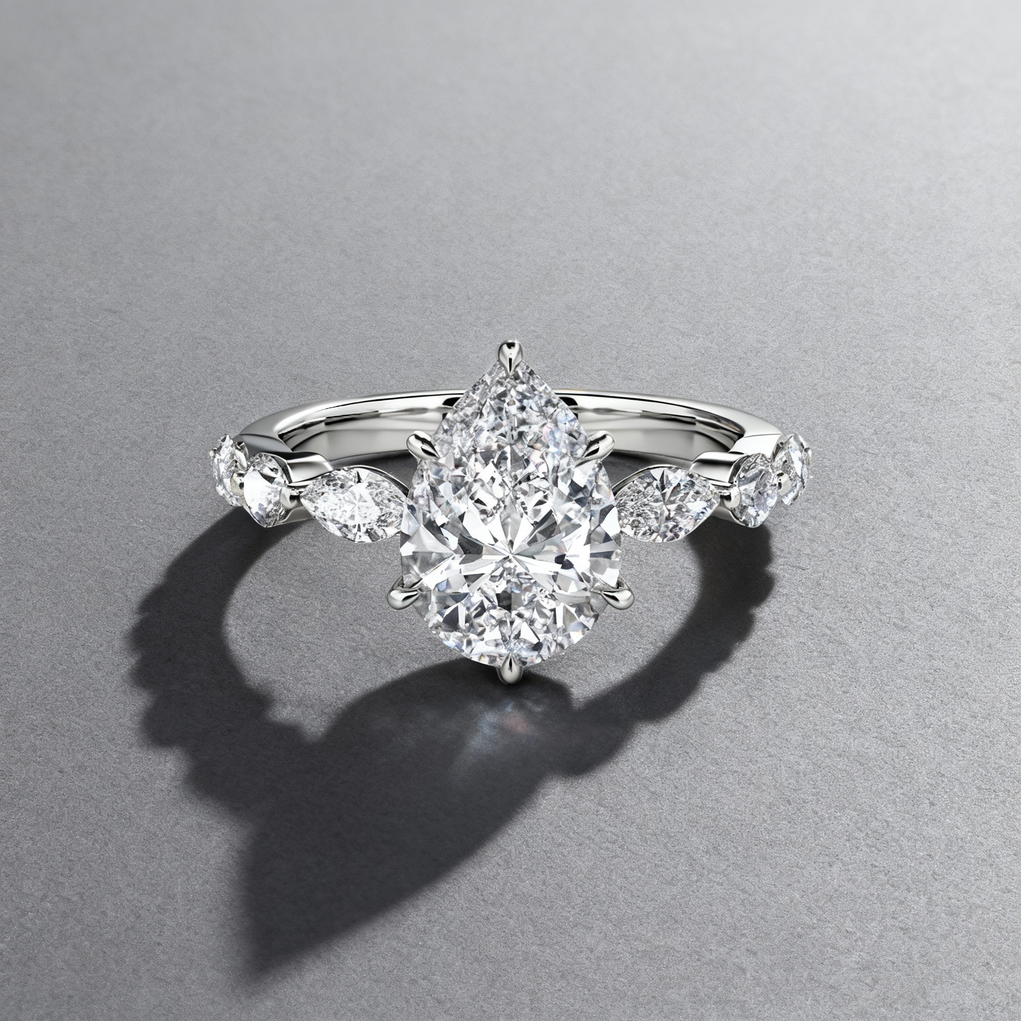 pear-cut side stone engagement ring