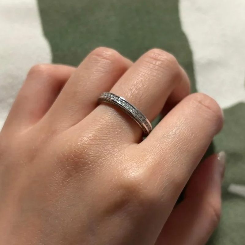 An eternity wedding ring worn on the left hand