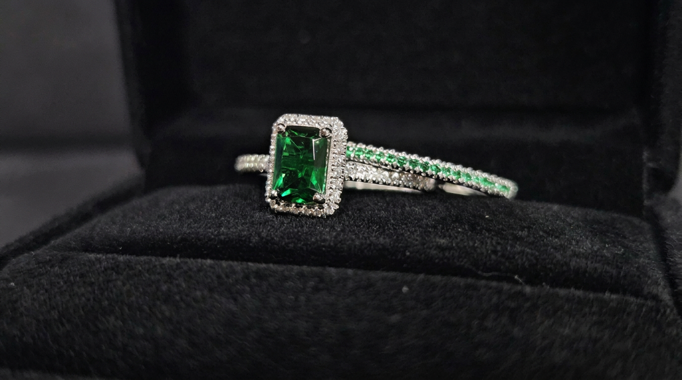 vivid green emerald engagement ring close-up in white gold